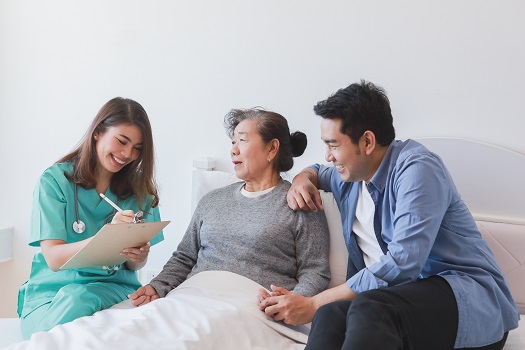 Asian Senior old woman on the bed with doctor and her son in hospital